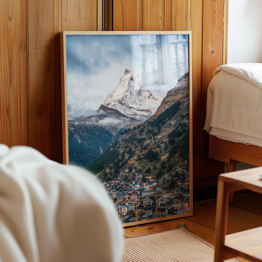 Matterhorn print propped in a wooden alpine bedroom with warm lighting.
