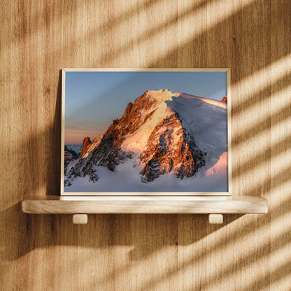Mont Blanc du Tacul print in a frame hung on a wooden wall, lit by natural sunlight