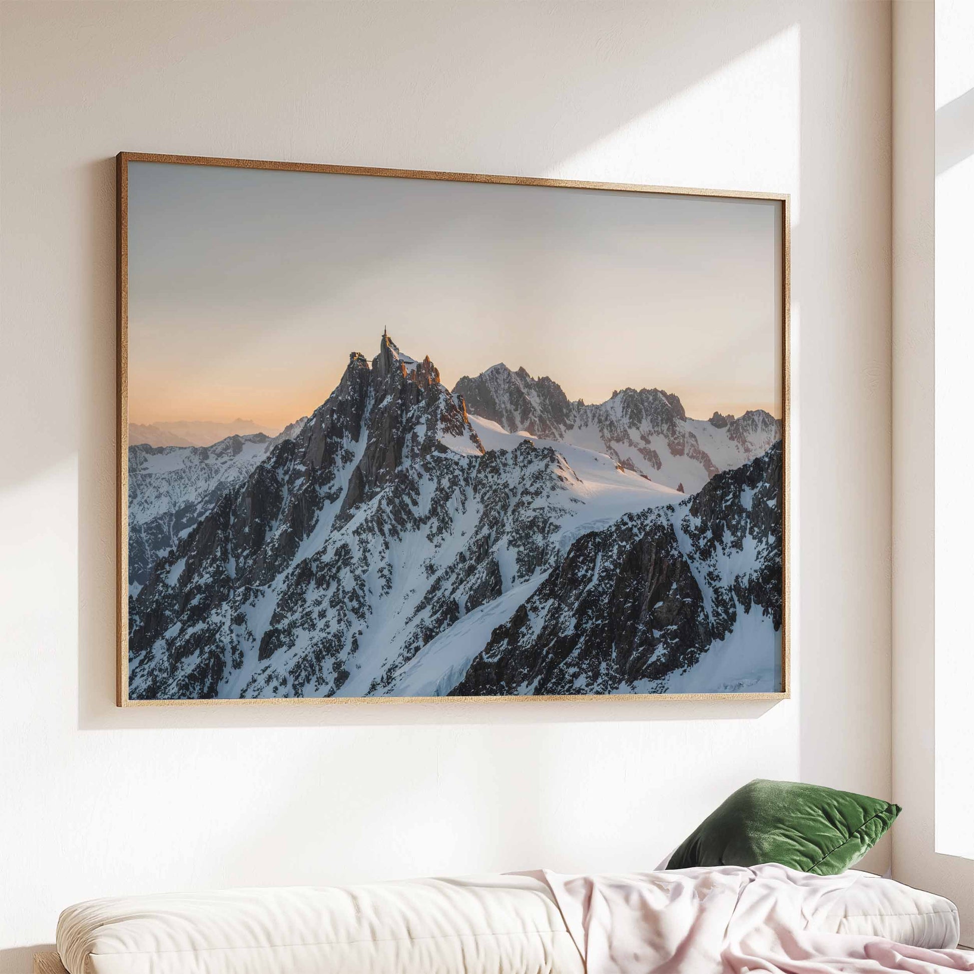 Elegant Aiguille du Midi mountain print at sunset, framed and displayed above a sofa.