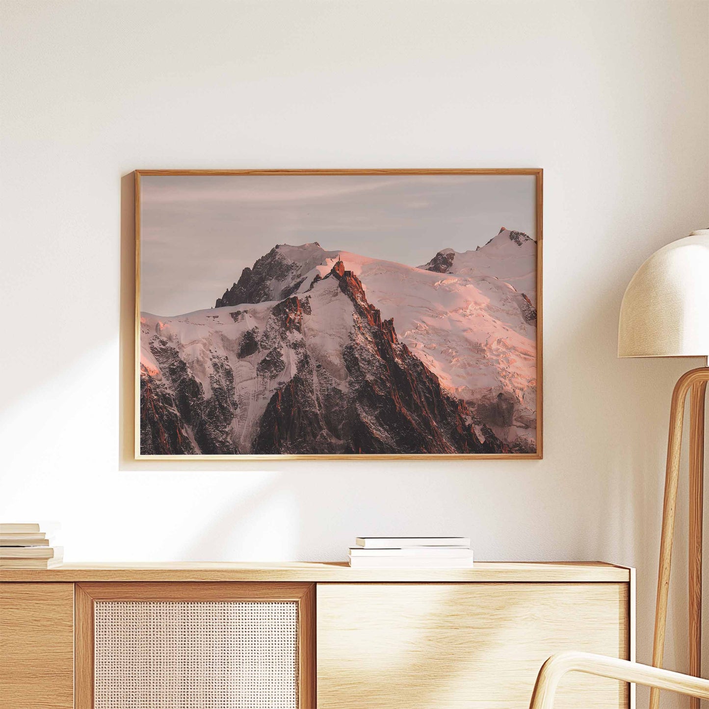 Aiguille du Midi sunset print in Chamonix, framed and styled on a wooden cabinet.