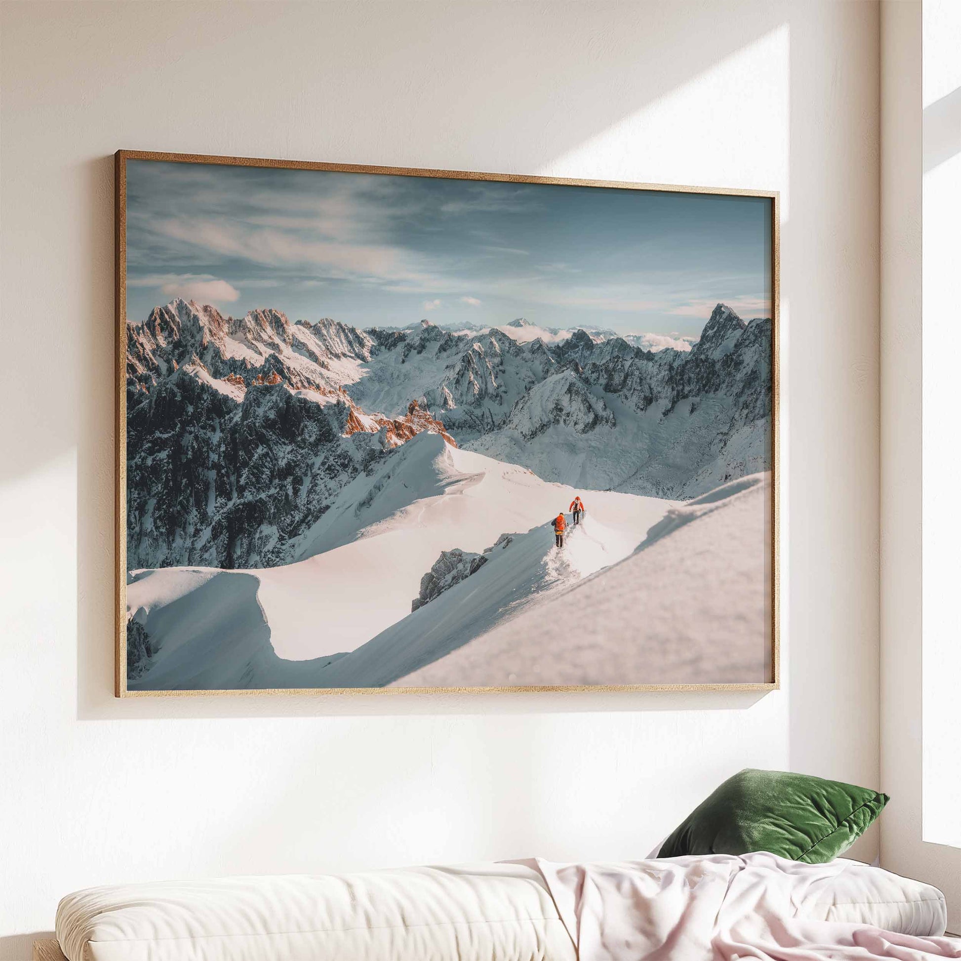 Aiguille du Midi mountaineering print featuring two climbers descending a snowy ridge, framed above a cozy sofa.