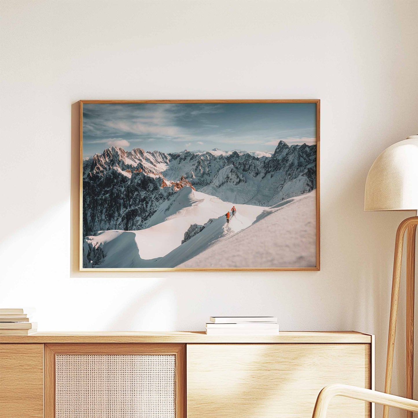 Beautiful mountaineering wall art print of the Aiguille du Midi ridge, framed and styled on a wooden cabinet.