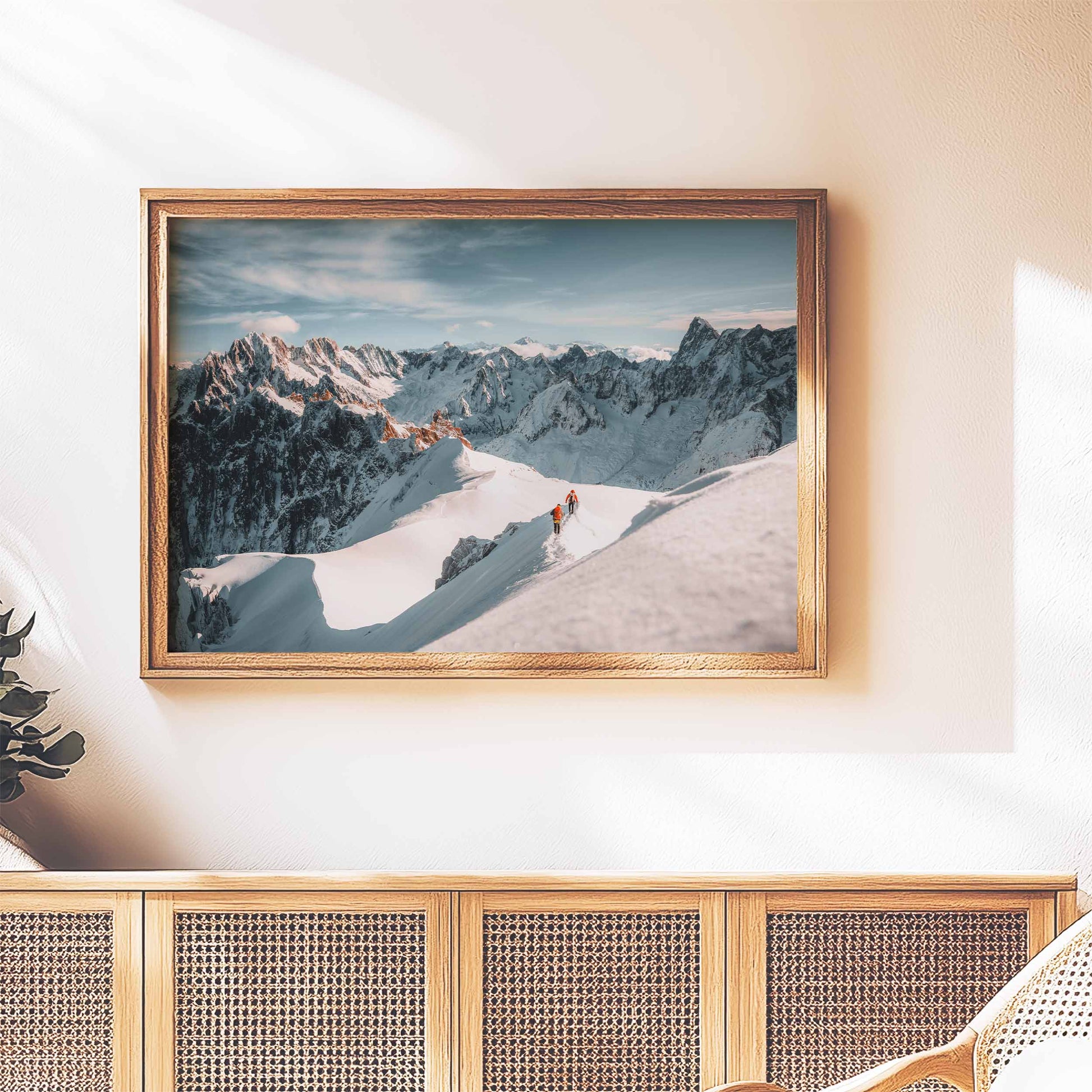 Rustic framed mountaineering print of the Aiguille du Midi arete, styled above a wooden sideboard for an adventurous touch.