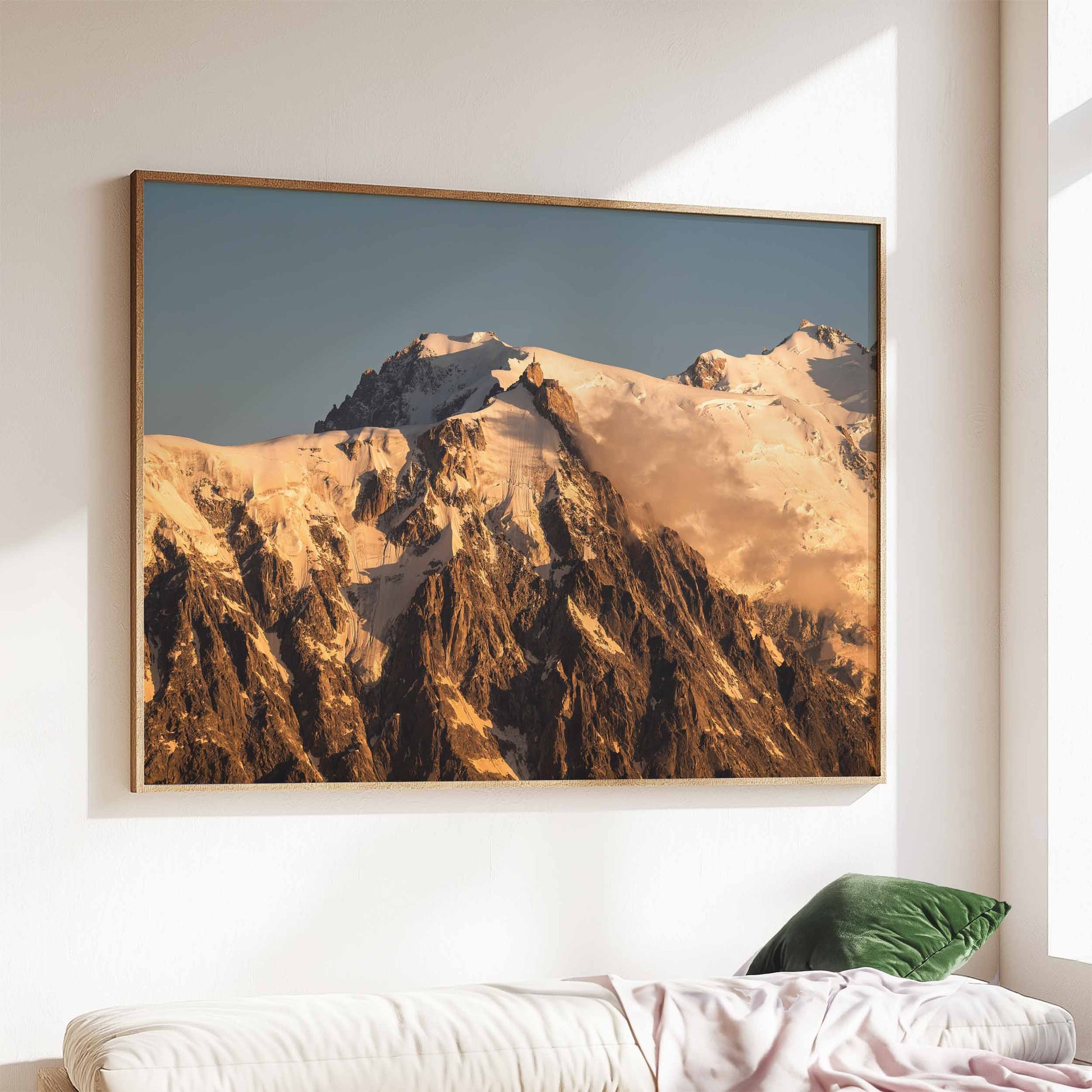 Aiguille du Midi mountain print at sunset, elegantly framed and displayed above a sofa with natural light.