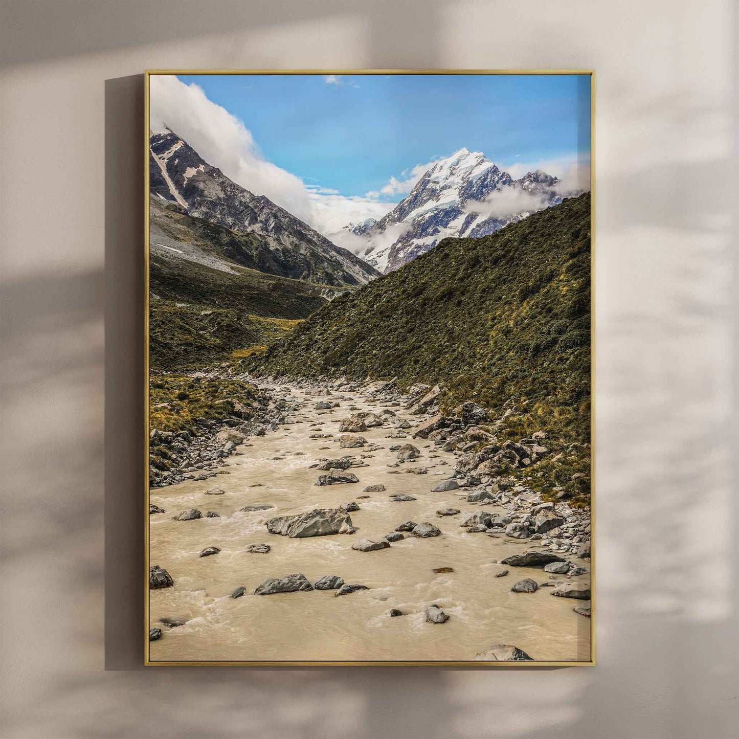 Framed print of Aoraki Mount Cook Hooker Valley New Zealand in a gold float frame mounted on a wall