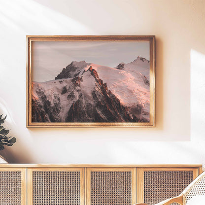 Chamonix mountain sunset print featuring the Aiguille du Midi, framed above a rustic wooden sideboard.