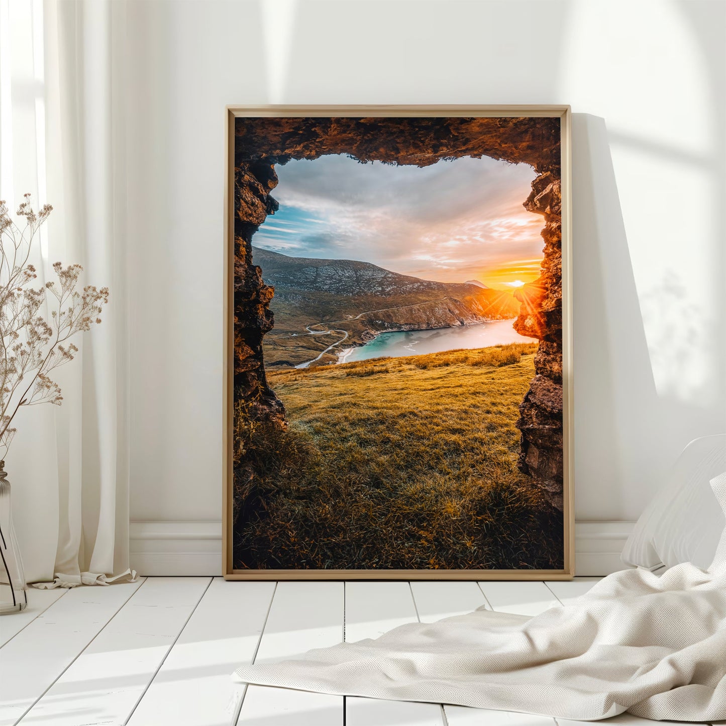 Golden light over Keem Beach on Achill Island with sea cliffs and winding road.