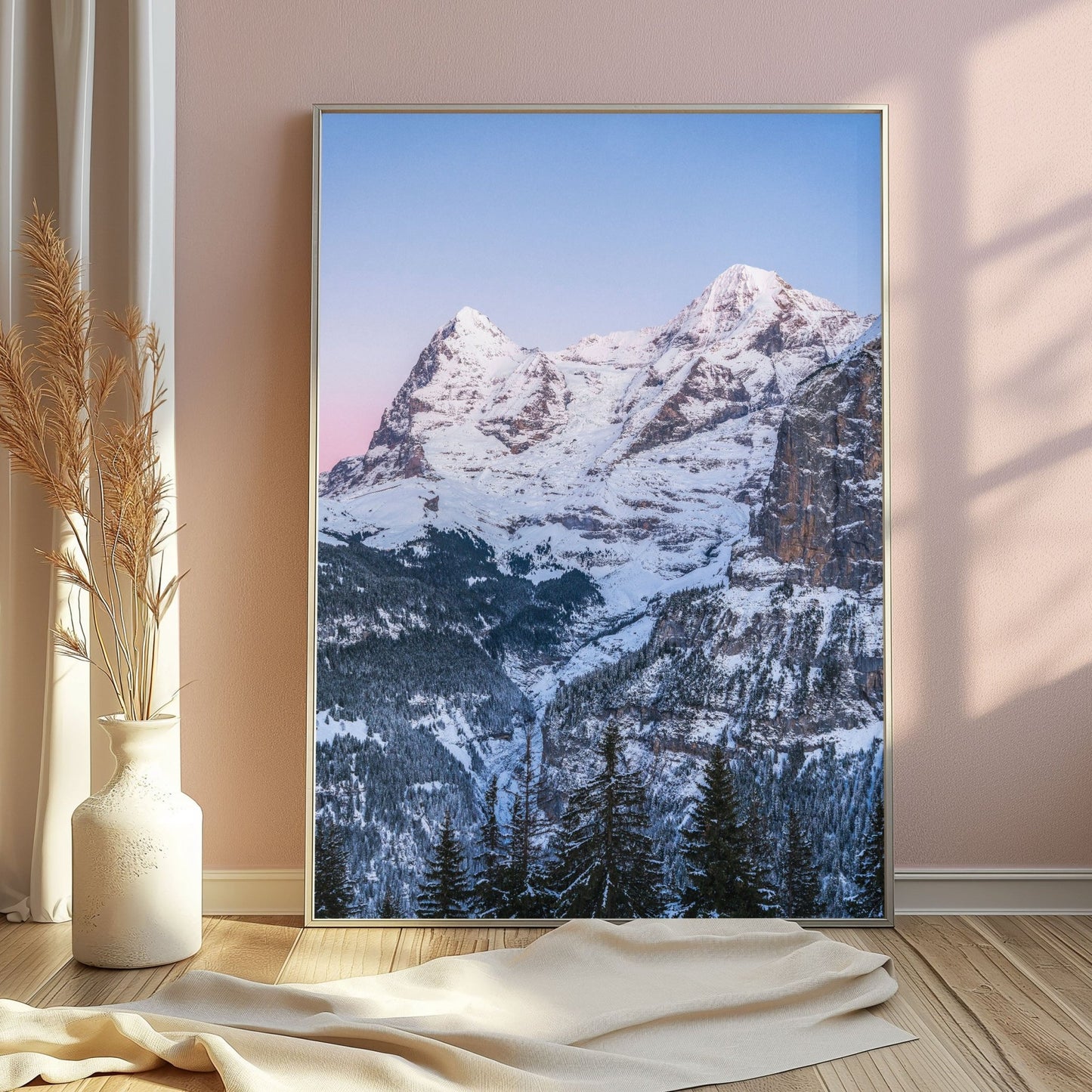 Winter wonderland of Eiger and Mönch mountains with trees in the foreground.