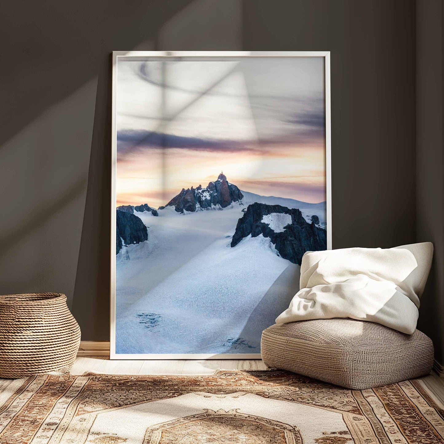 Modern framed wall art of the Aiguille du Midi sunset, white frame styled in a cozy room with natural decor.