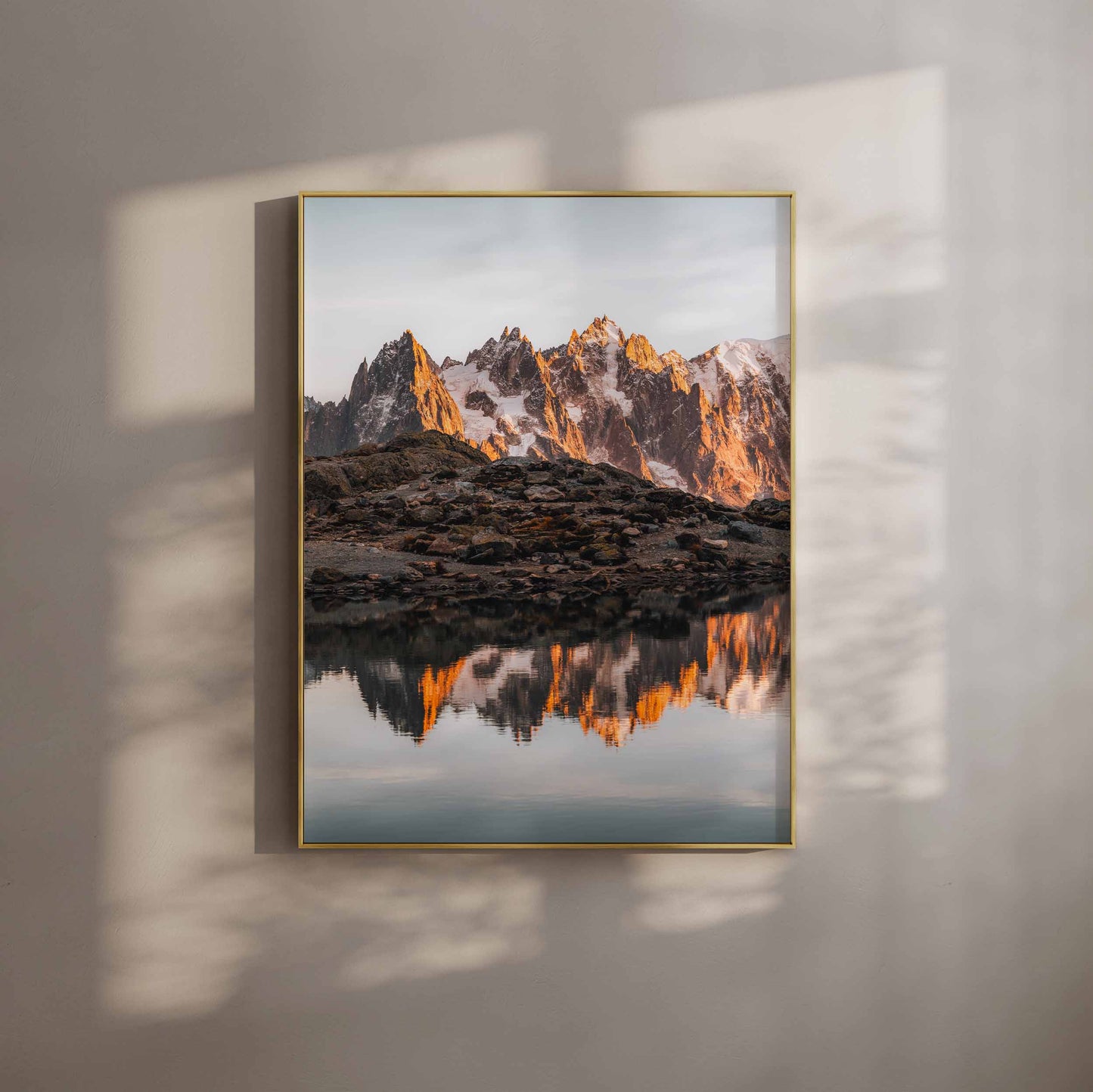 Golden peaks of Chamonix reflecting on the tranquil waters of Lac Blanc, framed in a modern gold design.