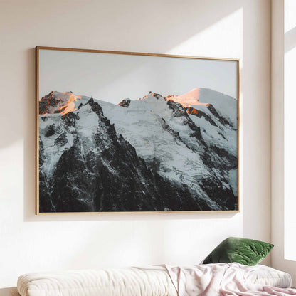 Mont Blanc massif sunset print, beautifully framed and displayed above a cozy sofa with natural lighting.