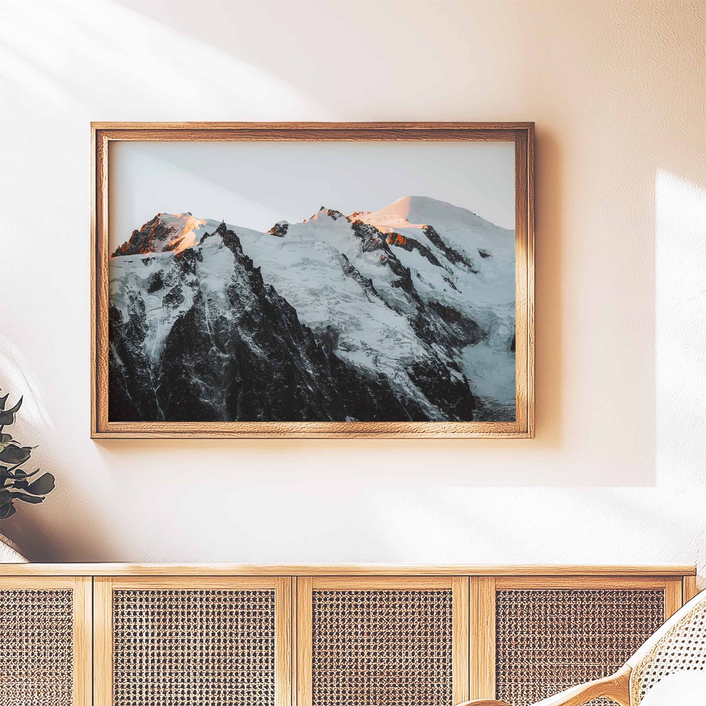 Rustic framed wall art of the Mont Blanc massif at sunset, styled above a wooden sideboard for a cozy touch.