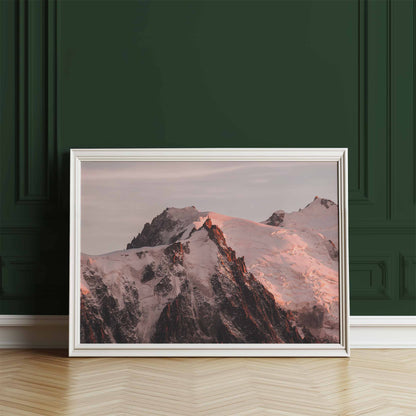 Chamonix mountain wall art of the Aiguille du Midi glowing at sunset, leaning against a green wall.