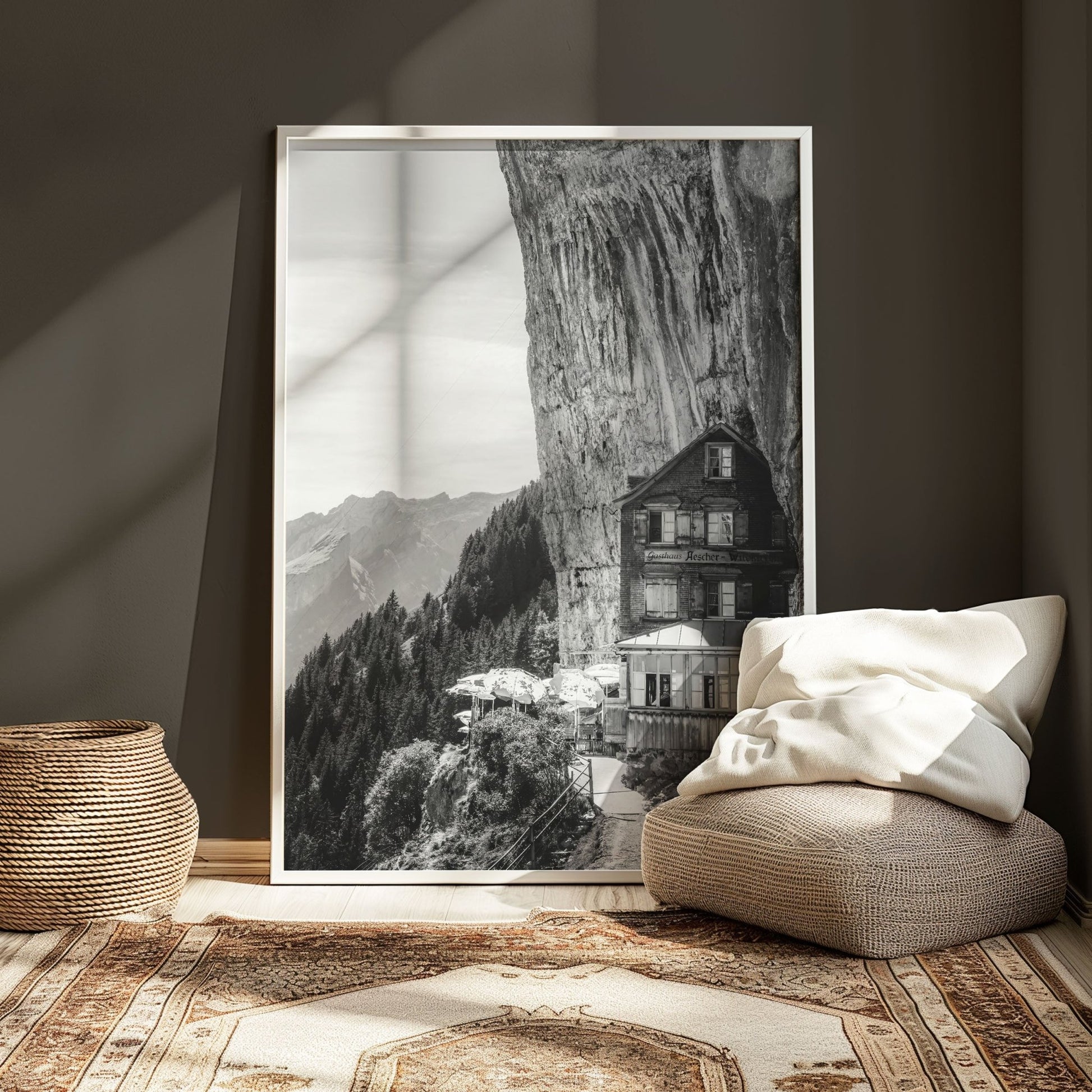 Monochrome view of the iconic Aescher Guesthouse, built into a Swiss cliffside, surrounded by mountains and forest for stunning decor inspiration.