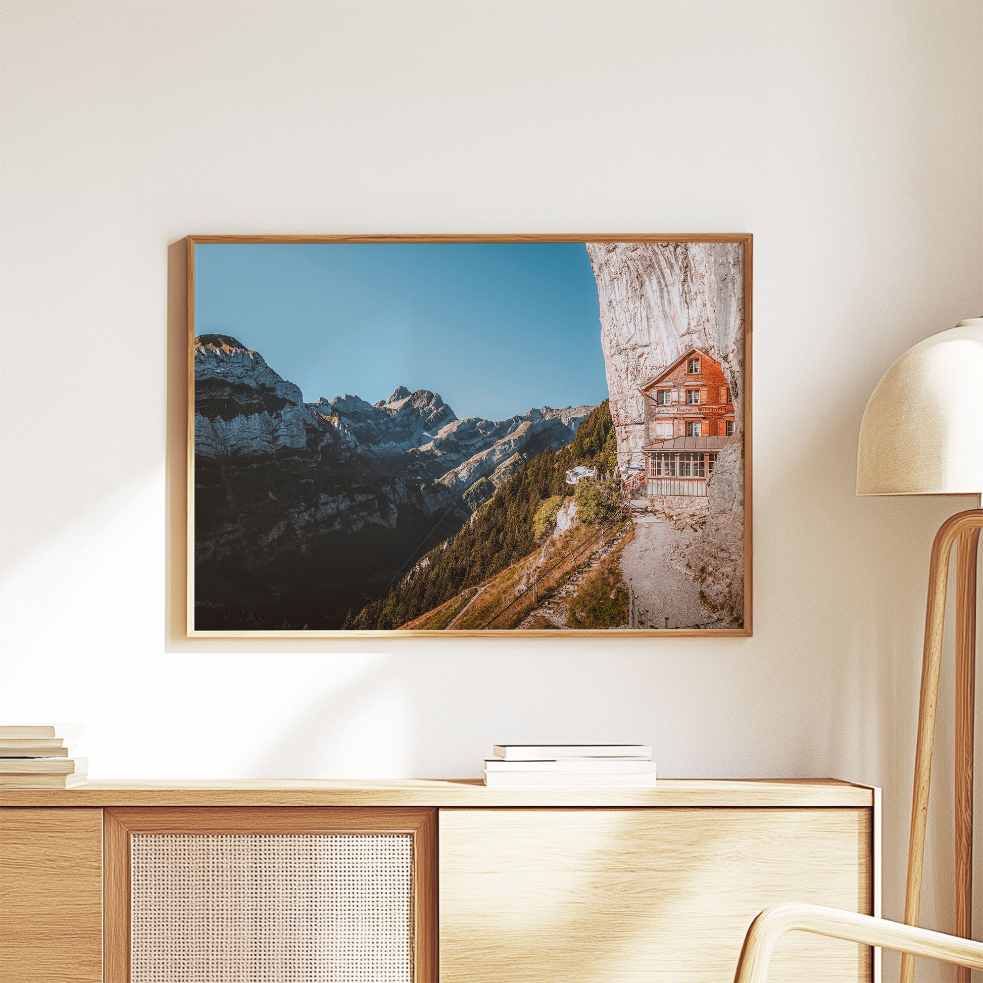 Aescher Guesthouse nestled in the Swiss Alps with clear skies and rugged cliffs, ideal for nature-inspired wall decor.