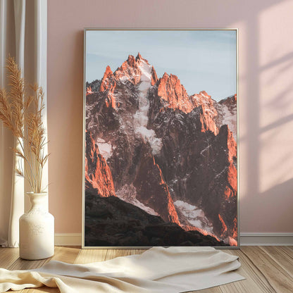 Stunning portrait of Aiguille de Chamonix with glowing sunset tones, styled against soft pink decor.