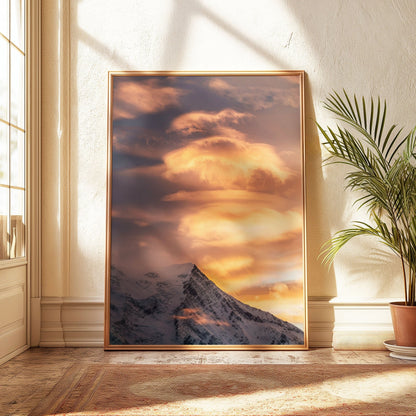 Aiguille du Gouter at sunset, showcasing dramatic clouds and golden tones over the French Alps.