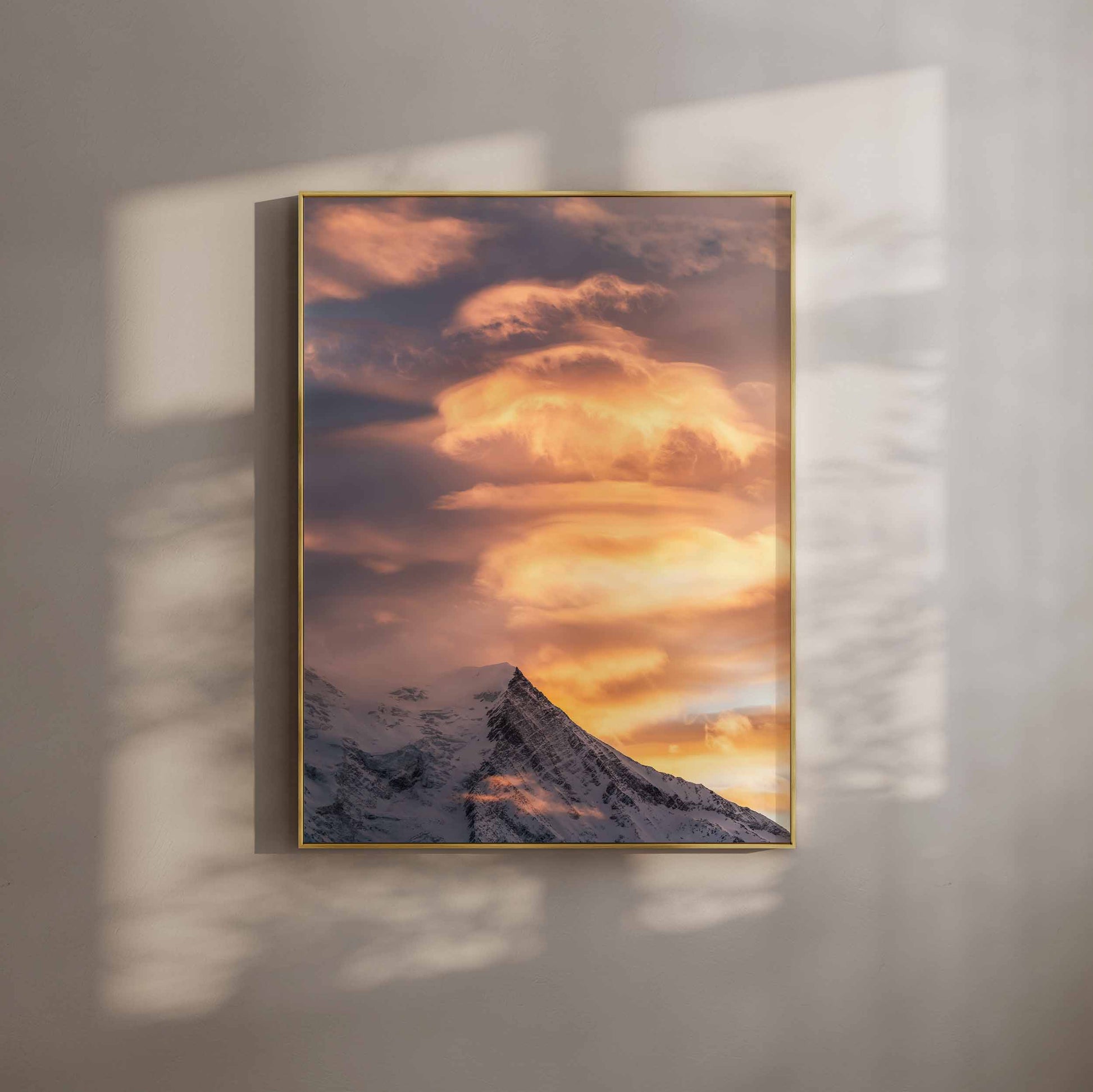 Aiguille du Gouter glowing under golden sunset light in the French Alps.