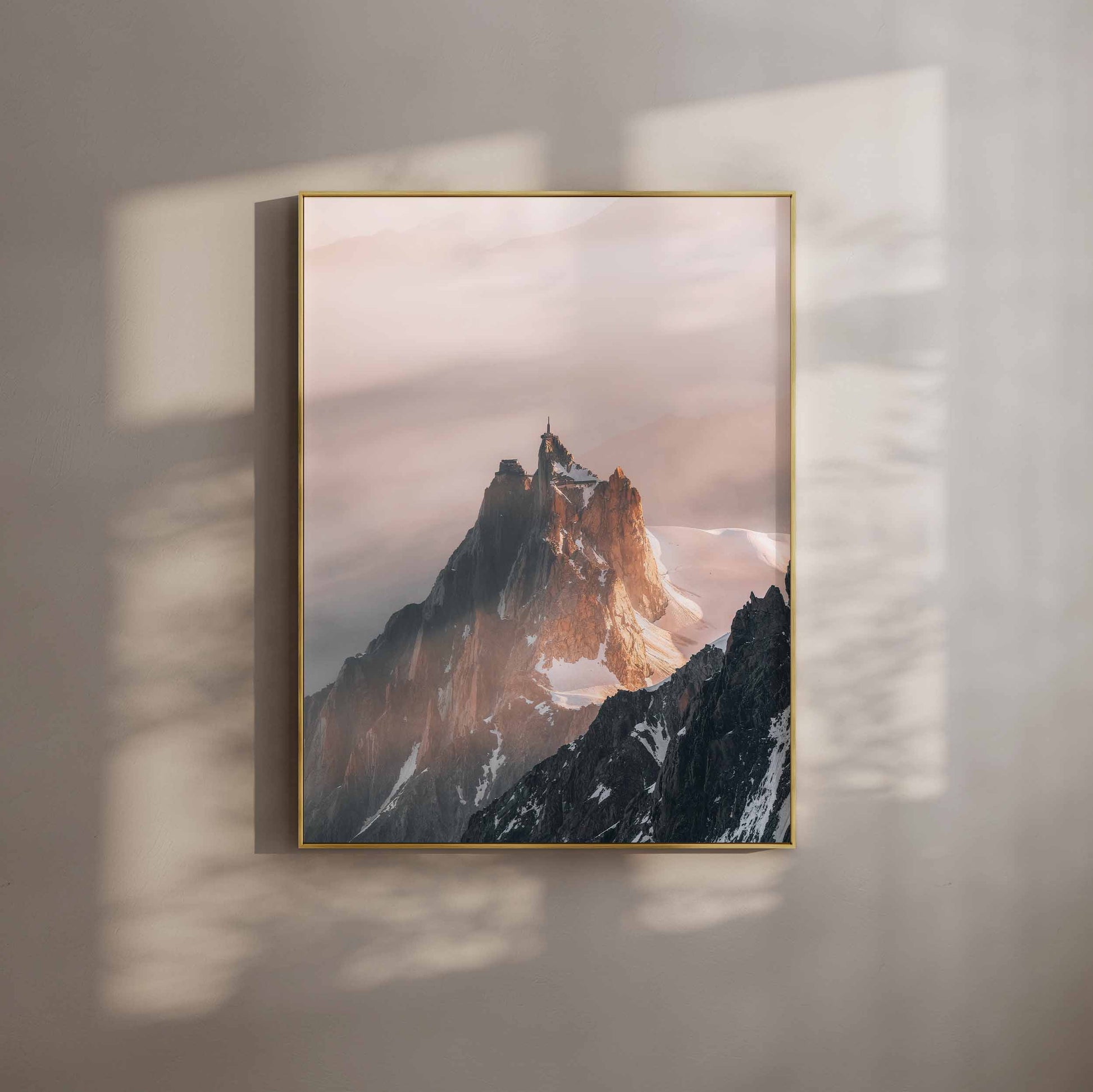 Aiguille du Midi softly glowing in warm evening light against a serene backdrop