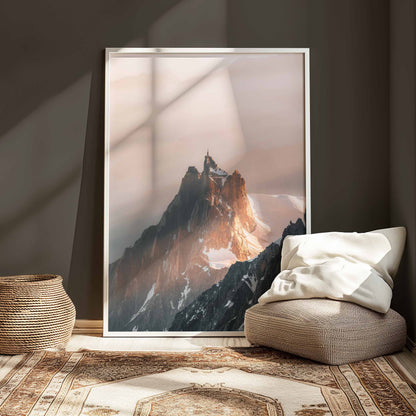 A framed Aiguille du Midi artwork displayed in a cozy living room with natural light highlighting the print.