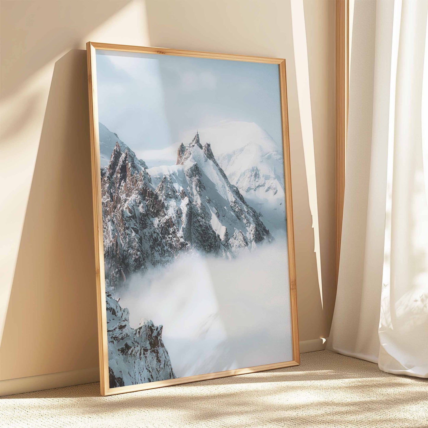 Frosty peaks of Aiguille du Midi surrounded by clouds in Chamonix.