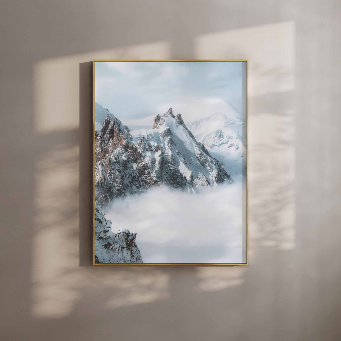 The iconic Aiguille du Midi peak surrounded by a dramatic mist-filled alpine backdrop.