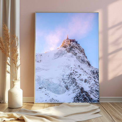 Beautiful sunrise over the Aiguille du Midi with soft pastel skies.