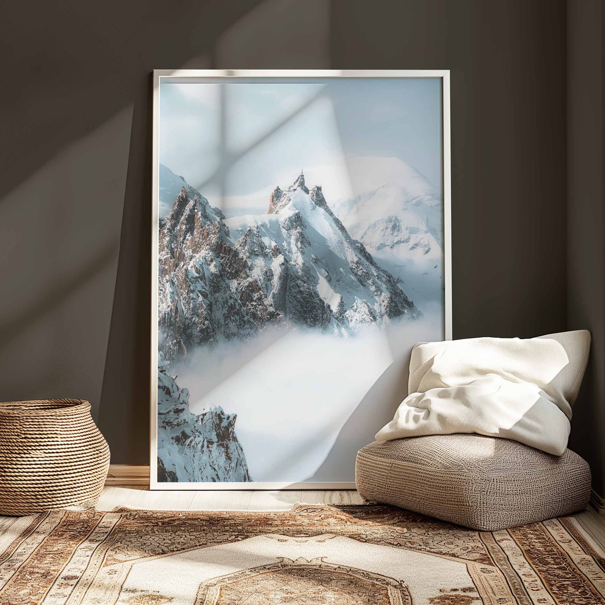 Snowy peaks of Aiguille du Midi emerging from clouds in Chamonix.