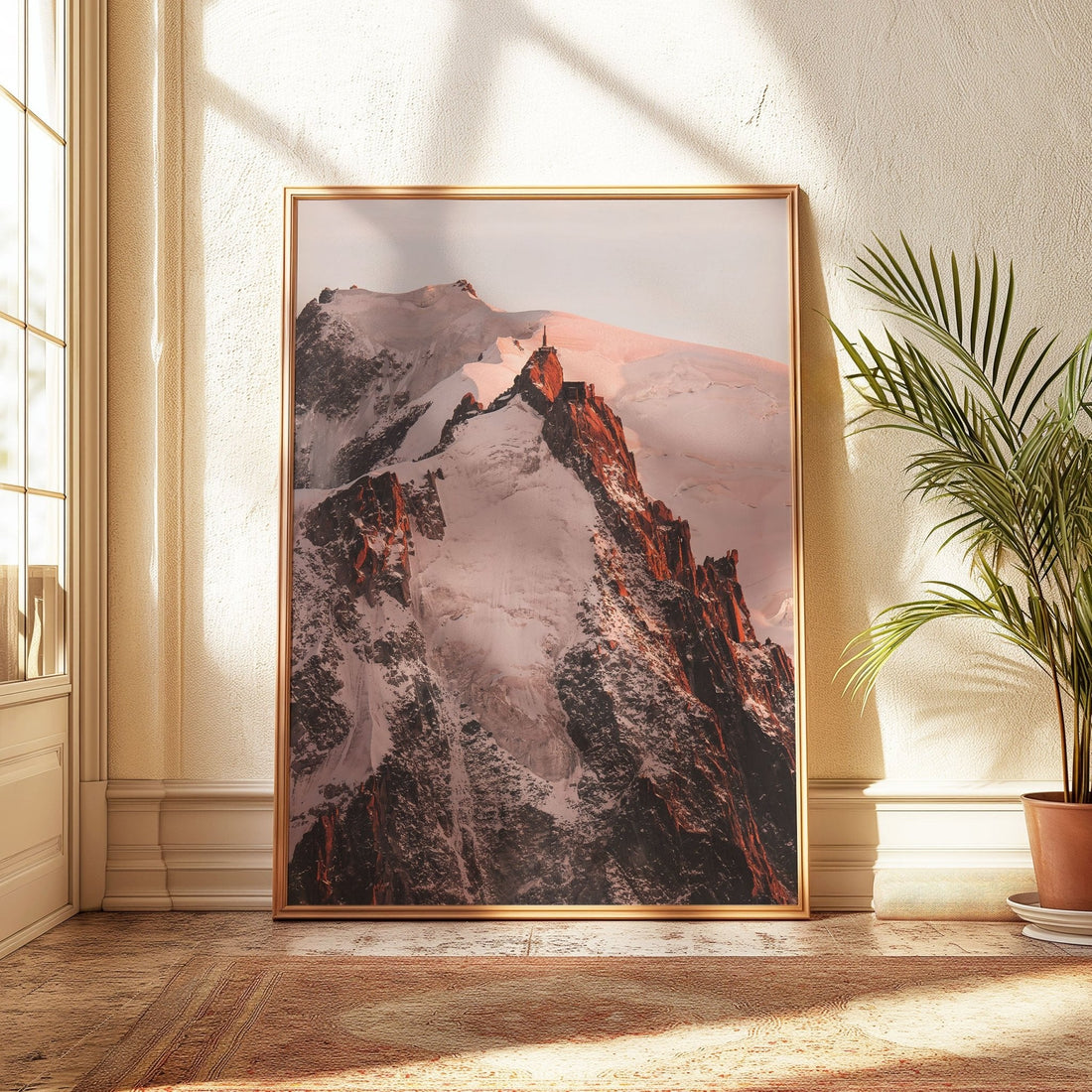 Aiguille du Midi summit glowing in warm pink sunset tones.