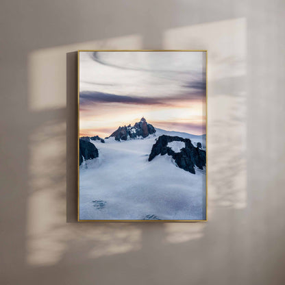 Fine art print of the Aiguille du Midi during sunset in Chamonix, France, gold frame on a shadowed wall.