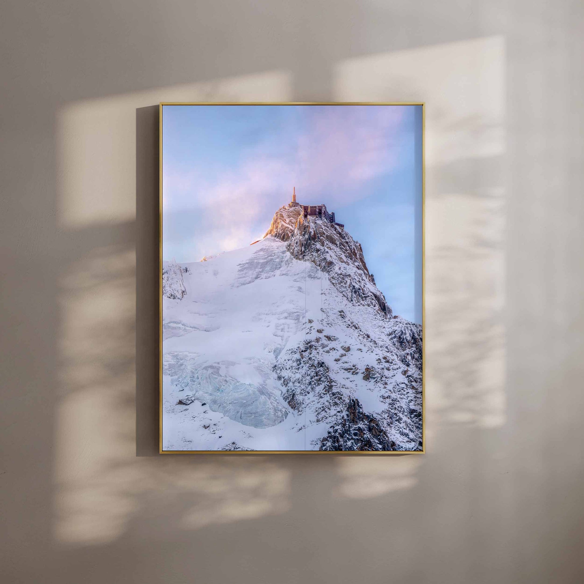 Aiguille du Midi with its summit structure glowing beautifully at sunset.