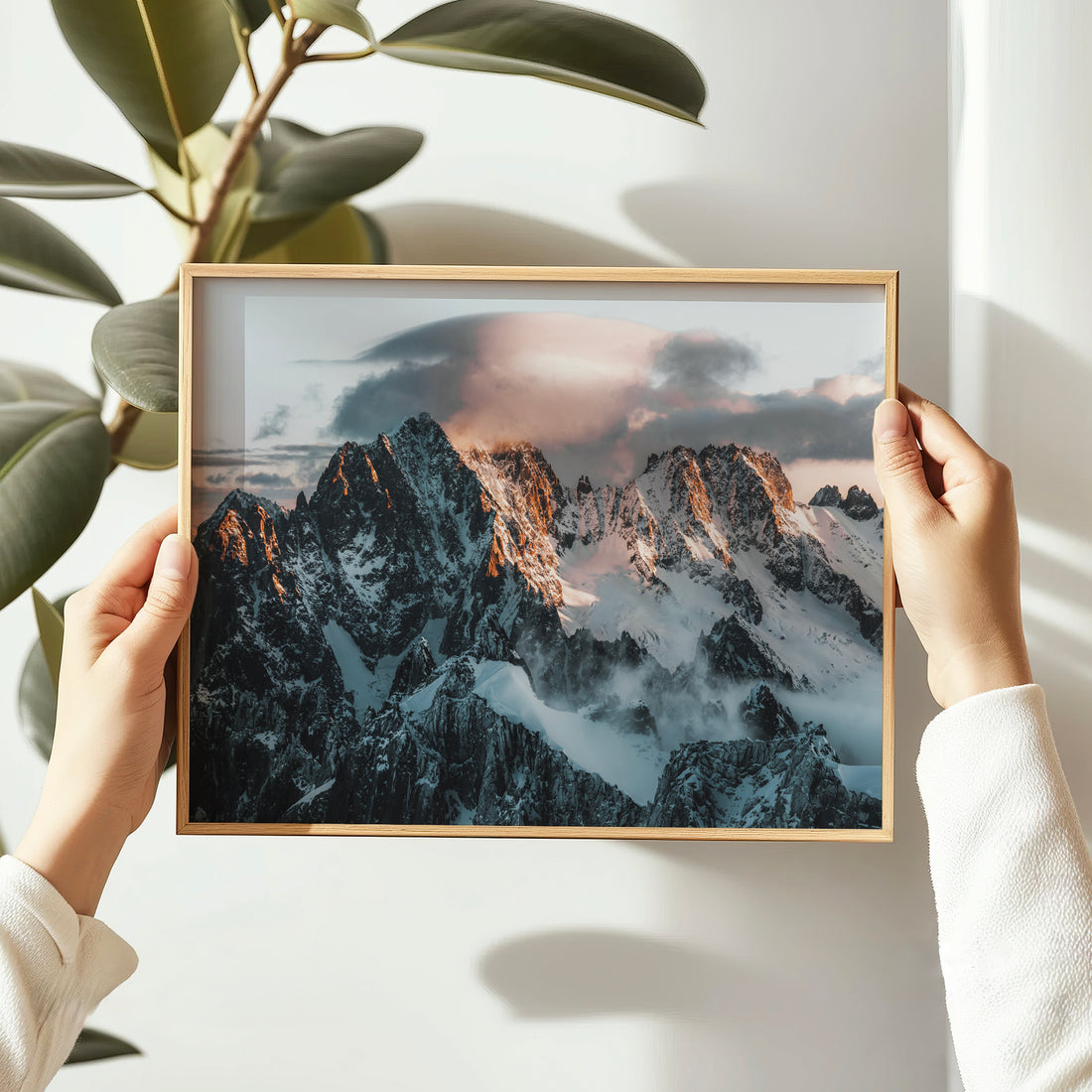 Hands holding framed Aiguille Verte sunrise print, Chamonix mountain wall art