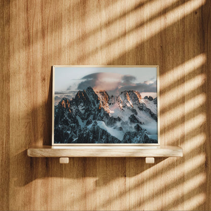 Aiguille Verte sunrise mountain print displayed on wooden shelf, alpine photography wall art