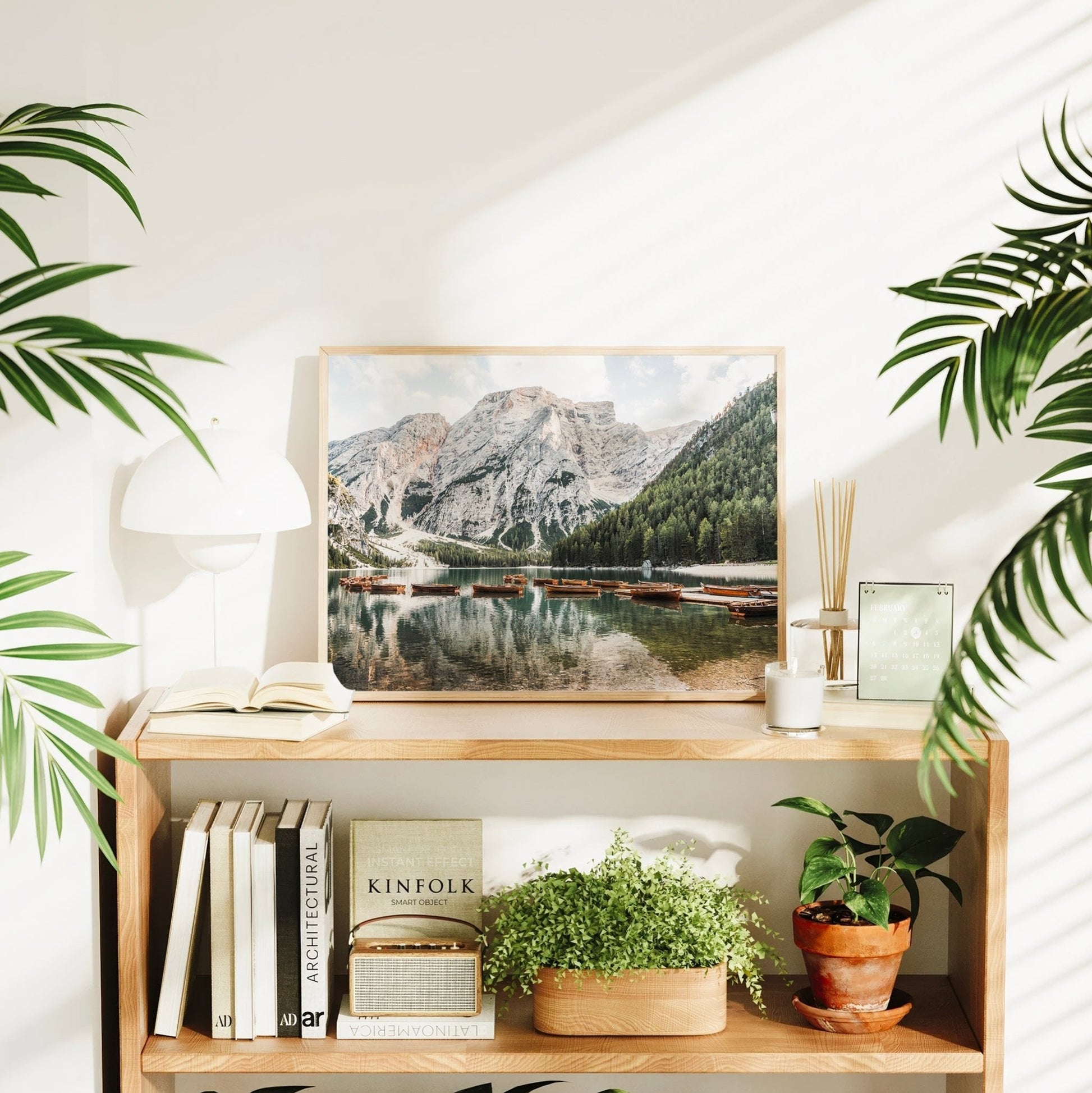 Italian Alps wall art of tranquil Lago di Braies featuring iconic wooden rowboats, forest shoreline, and striking Dolomite cliffs.