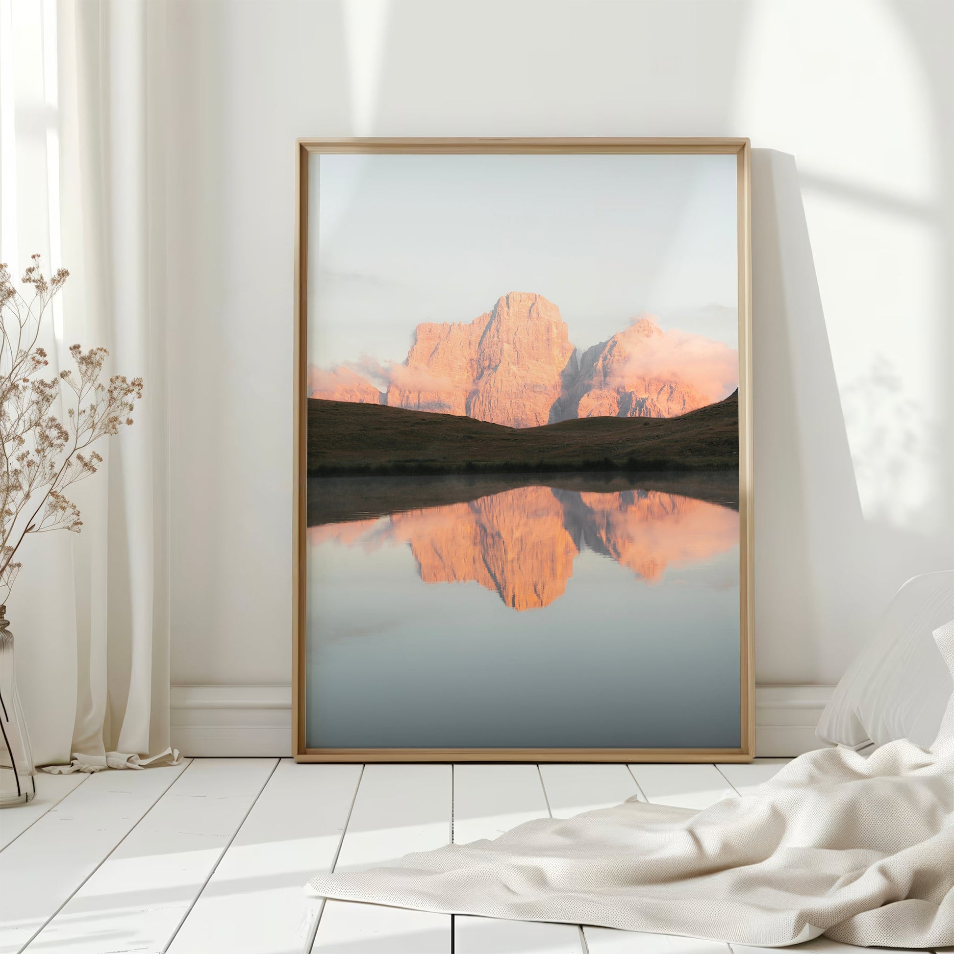 Fine art Dolomites print styled on bookshelf with morning light