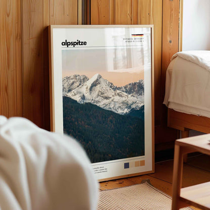Framed Alpspitze Bavaria Germany landscape print in natural wood frame leaning against pine panelled bedroom wall