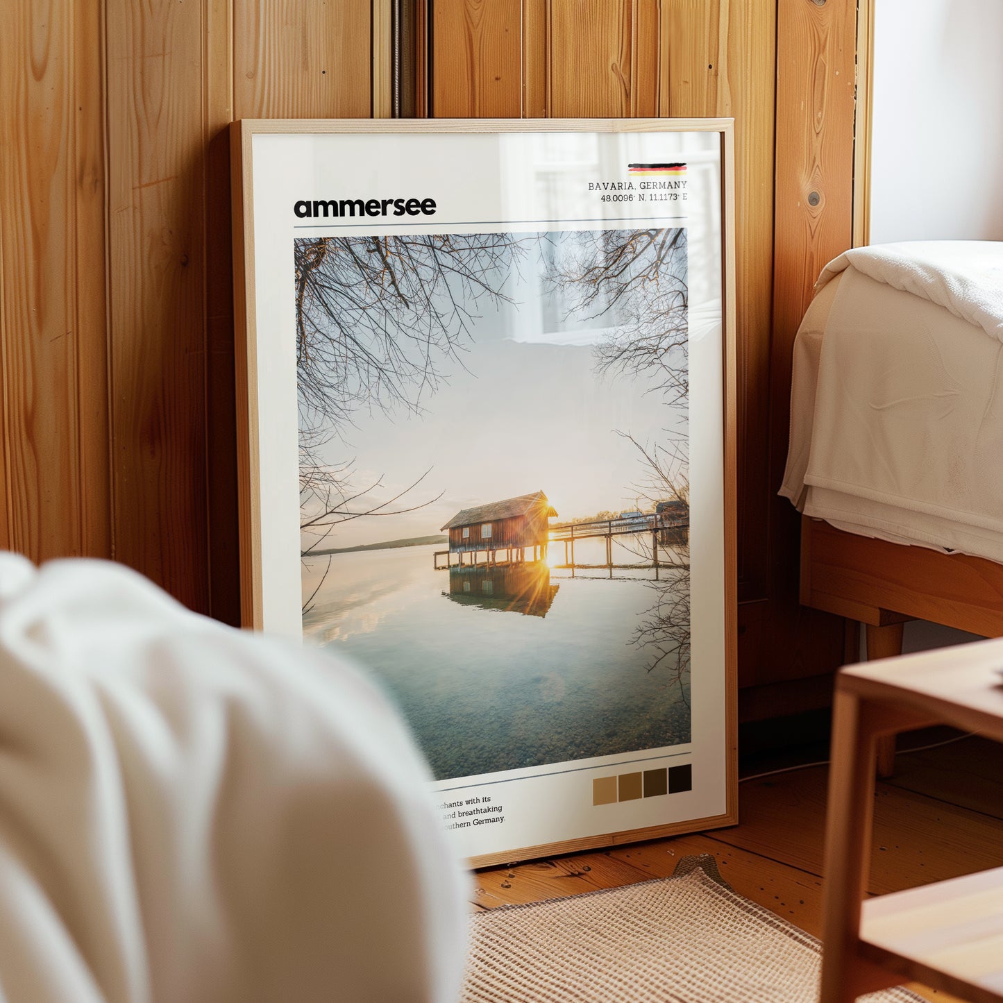 Framed Ammersee Bavaria Germany boathouse landscape print in natural wood frame leaning against pine panelled bedroom wall