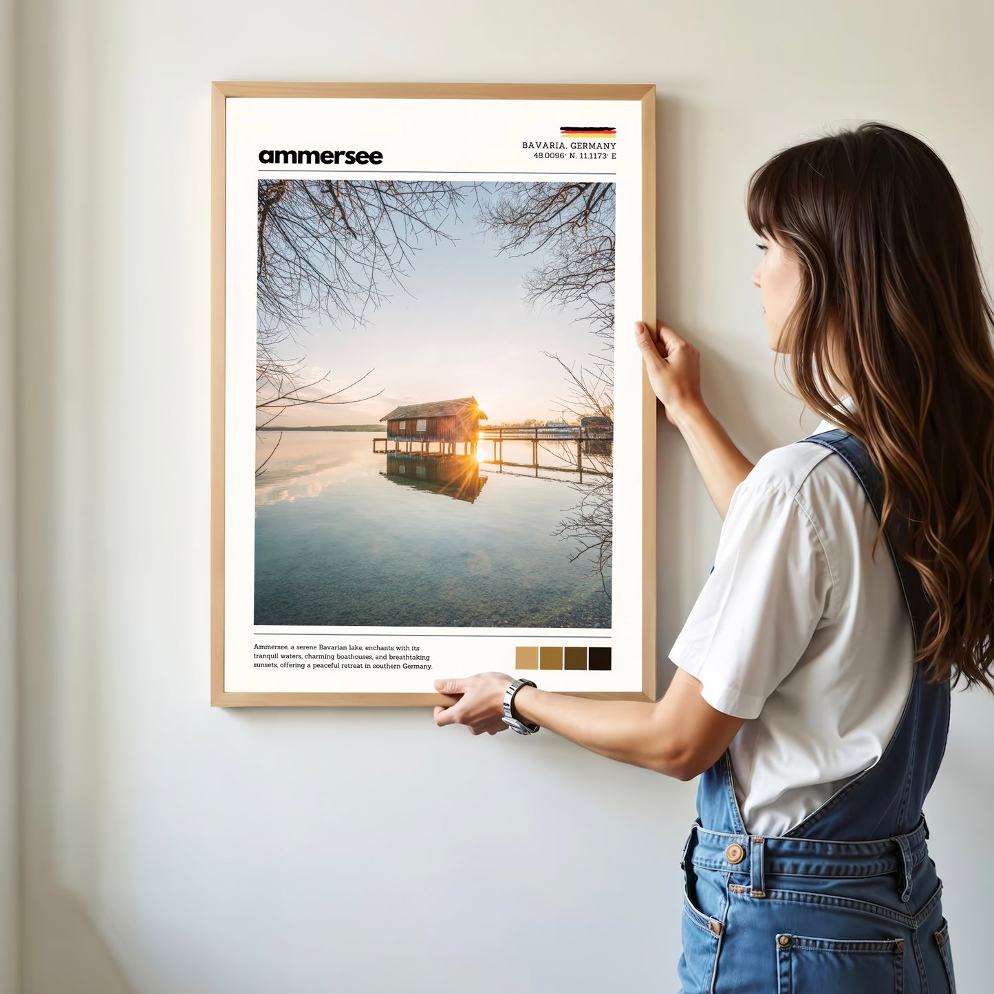 Woman hanging framed Ammersee Bavaria Germany boathouse photography print in natural oak frame on white wall