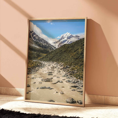 Natural wood framed Aoraki Mount Cook Hooker Valley New Zealand print leaning against a terracotta wall