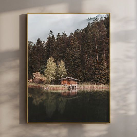 Wooden hut on Mittersee lake surrounded by alpine forest in Austria