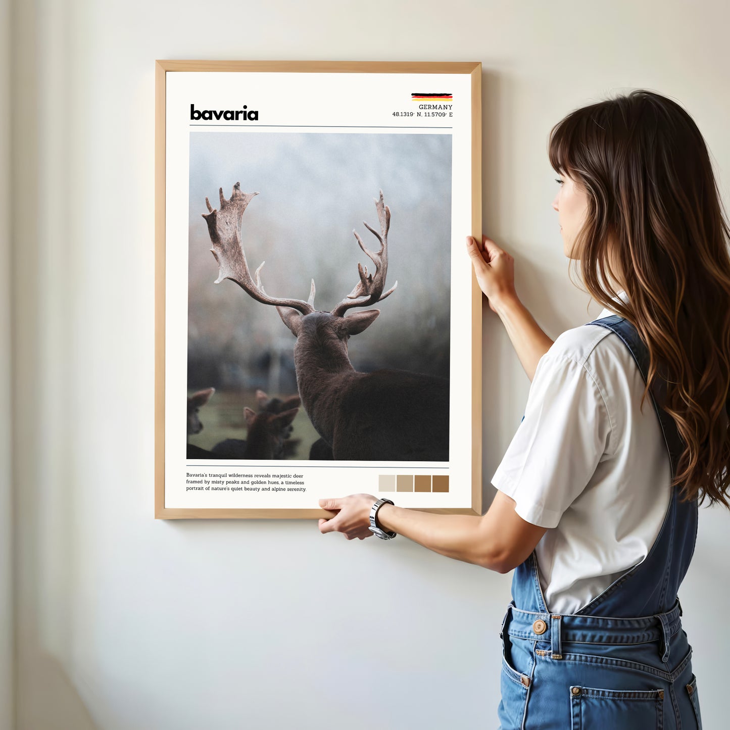 Woman hanging framed Bavaria red deer stag Germany wildlife photography print in natural oak frame on white wall