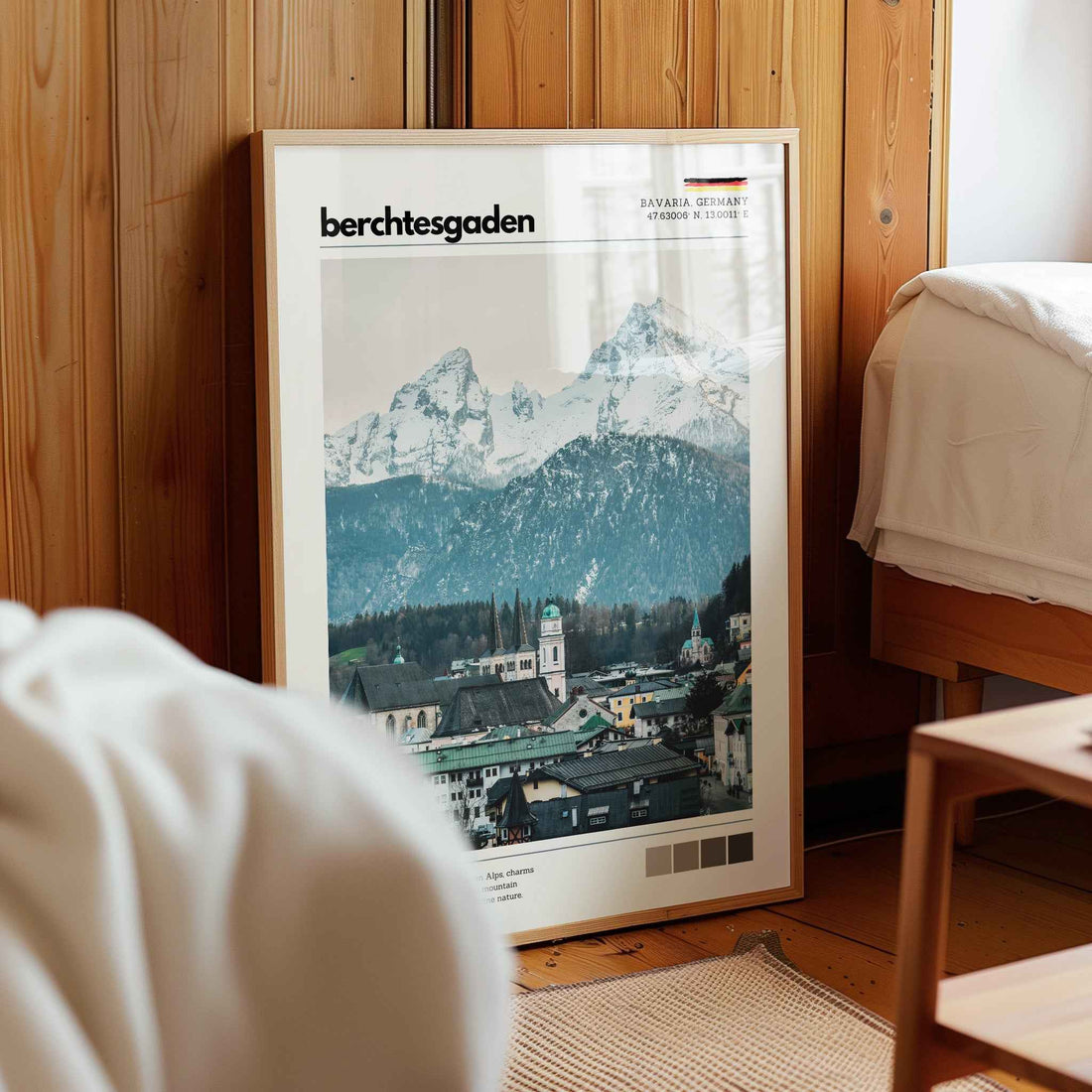 Framed Berchtesgaden Bavaria Germany alpine town print in natural wood frame leaning against pine panelled bedroom wall
