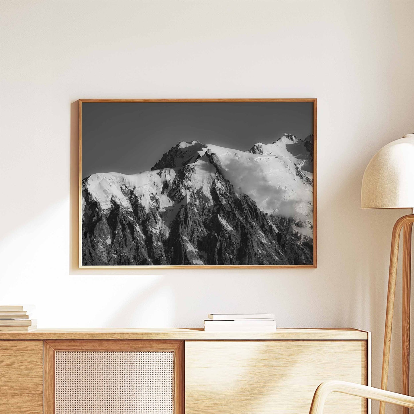 Minimalist decor featuring a framed black and white photo of the Aiguille du Midi, styled with warm wood tones.