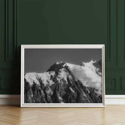 Framed black and white image of the Aiguille du Midi against a dark green wall.