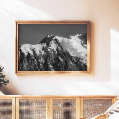 Aiguille du Midi black and white photograph styled in a wooden frame above a rattan console