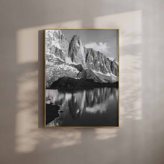 Black and white photograph of Les Drus mountain reflecting in a tranquil alpine lake, perfect for wall art.