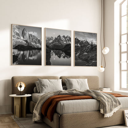 Set of three black and white framed prints of Chamonix landscapes in a cozy bedroom