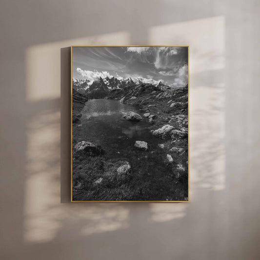 Black and white photo of Lac Flégère in Chamonix, showcasing serene alpine waters and rugged terrain.