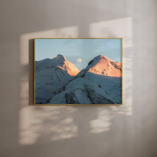 Castor and Pollux mountains glowing in evening sunlight with the moon overhead, perfect for mountain wall art decor.