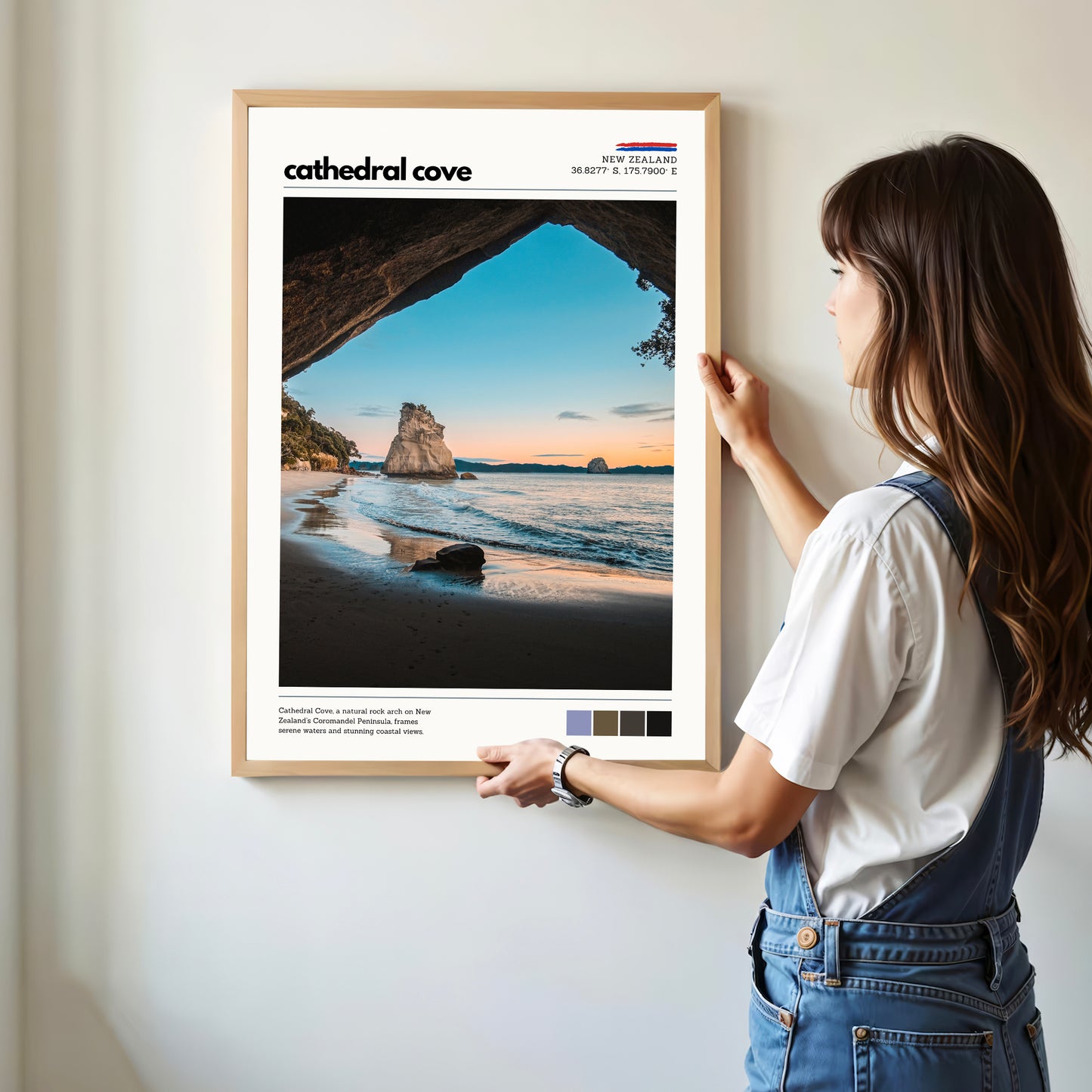 Person hanging a Cathedral Cove wall art print in a modern home interior